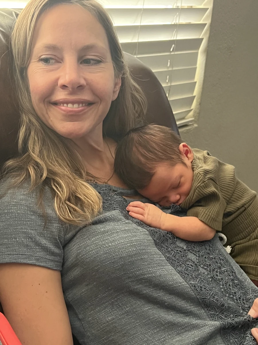 Dr. Dana Rodriguez, PhD holding a newborn patient